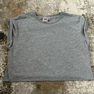 Loose fitting crop top with rolled up short sleeves